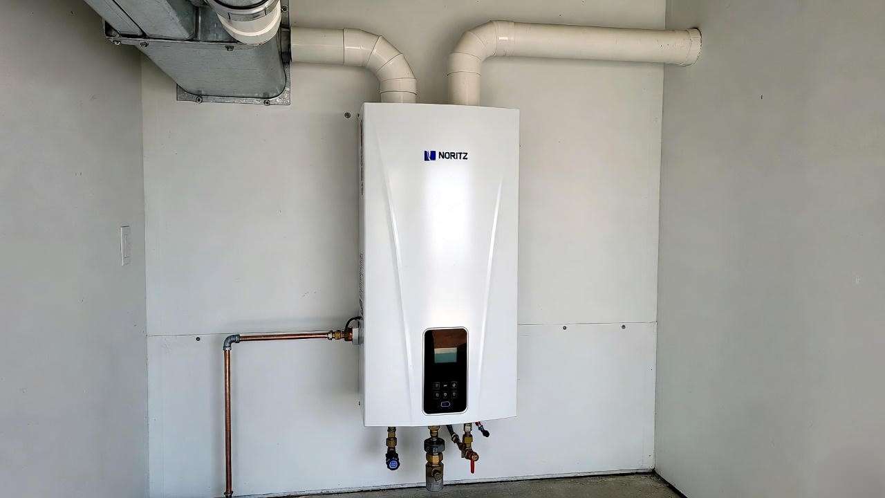 Noritz condensing tankless water heater professionally installed with copper gas line and PVC venting
