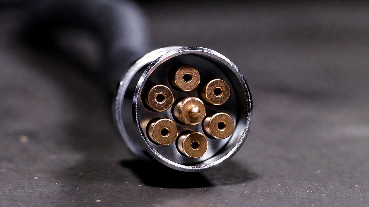 Close-up of SAE J560 7-pin round trailer connector showing pin arrangement and metallic finish
