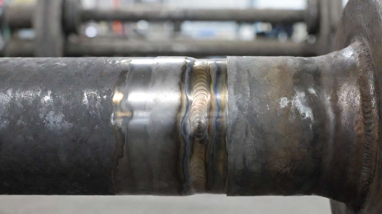 High-quality code-compliant SMAW pipe weld with smooth cap pass and perfect reinforcement