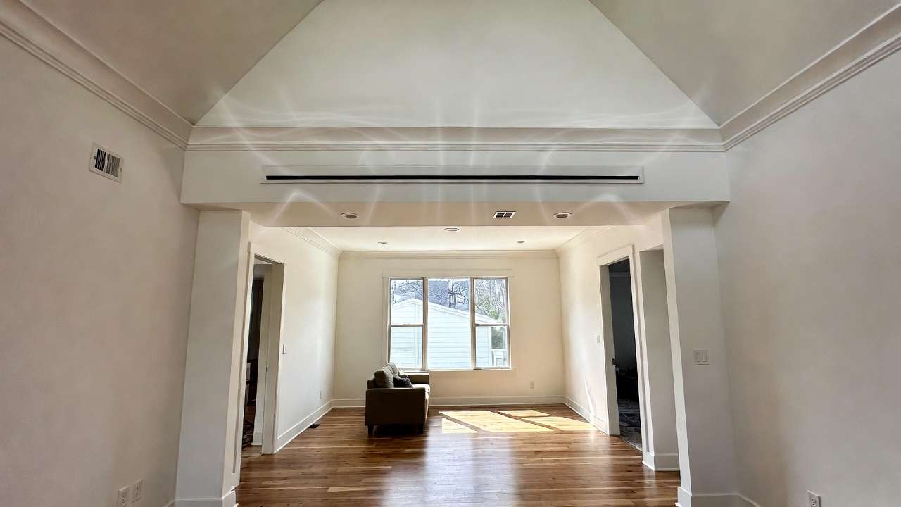 Discreet high-velocity mini-duct AC outlet in ceiling of modular home interior