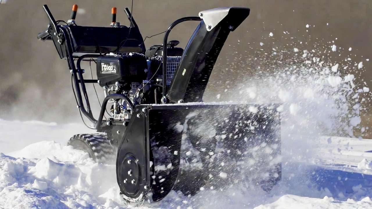 Two-stage auger and impeller mechanism actively clearing snow in autonomous robotic snow blower engineering.